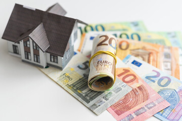 Small Model House on Layer of One Hundred Dollar Bills.