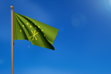 Adygea. Flag blown by the wind with blue sky in the background.