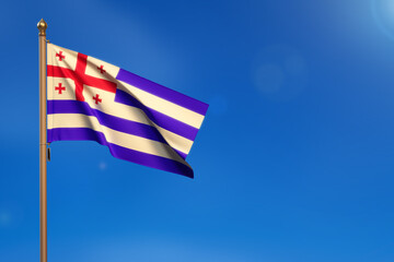 Ajaria. Flag blown by the wind with blue sky in the background.