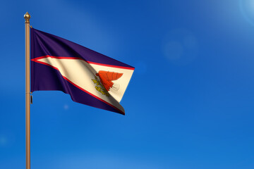 American Samoa. Flag blown by the wind with blue sky in the background.