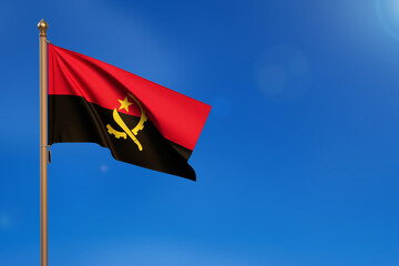 Angola. Flag blown by the wind with blue sky in the background.