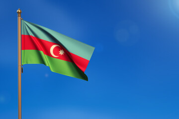 Azerbaijan. Flag blown by the wind with blue sky in the background.