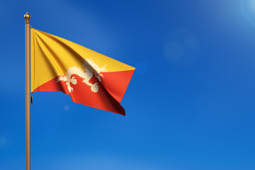 Bhutan. Flag blown by the wind with blue sky in the background.