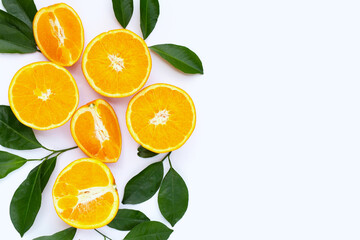 Orange fruit with green leaves on white background.
