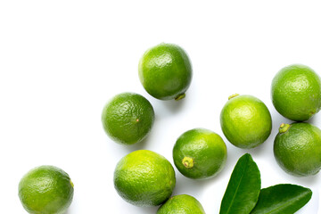 Fresh limes and leaves with wooden juicer on white background.