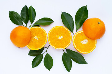 Orange fruit with green leaves on white background.