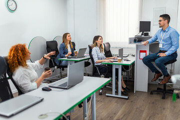 Educator and students in programming school