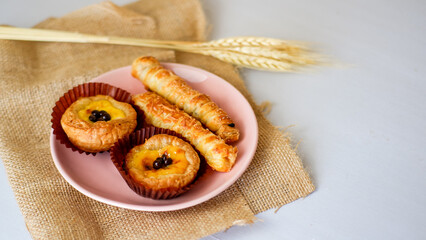 cheesy egg tart and cheese roll, crispy puff pastry with cheese stick inside.