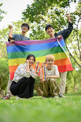 A group of happy young Asian diversity friends with the LGBT rainbow flag outdoors
