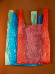 Many Plastic Bags on Brown Background. Crumpled Plastic Bag after Shopping, Cellophane Packaging Waste