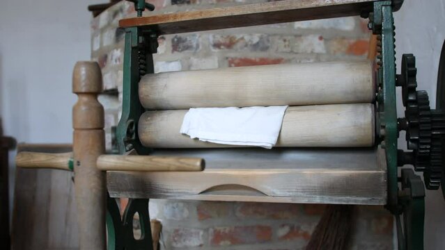 A victorian wash room kitchen laundry washing mangle press machine close up