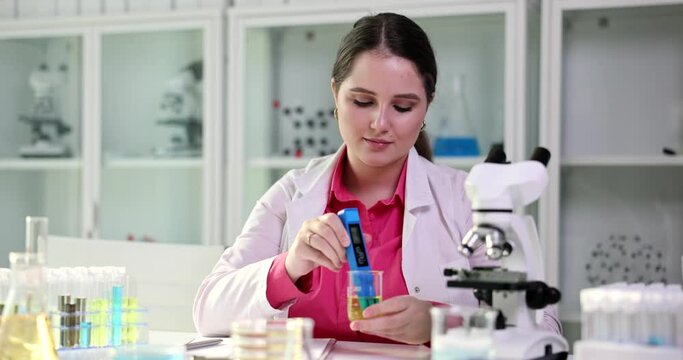 Doctor tests urine for infections and various substances. Scientist examining urine or oil in lab