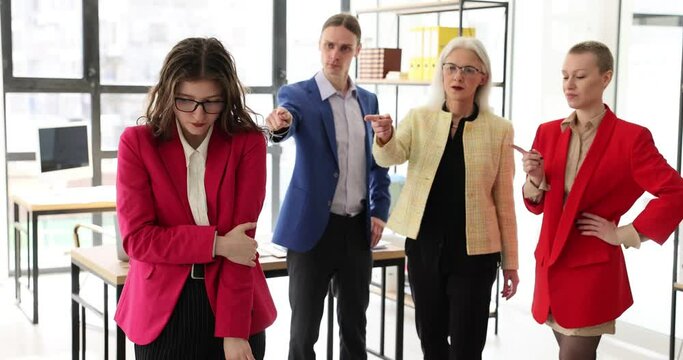 Frustrated tired female employee feels stressed, suffers from bad attitude and discrimination of colleagues. Business people group blaming female student colleague for incompetence gender inequality