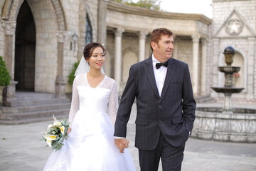 The wedding photos of a western male and Vietnamese women in outdoor settings