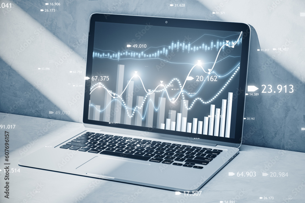 Poster close up of laptop at workplace with creative candlestick forex chart or graph on blurry background.