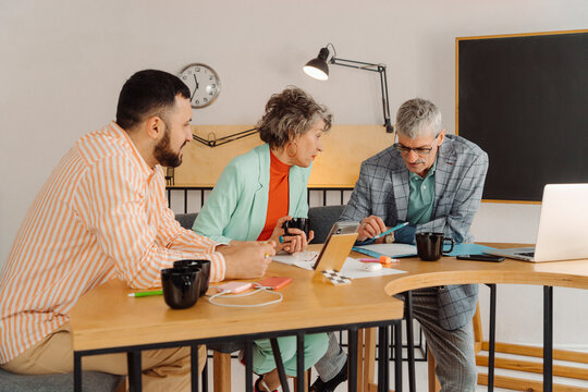 Business people recording online stream sitting at desk in the studio