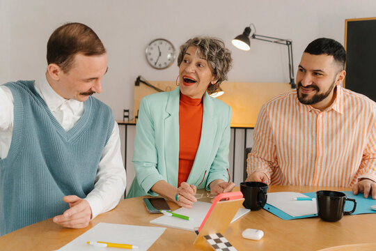 Colleagues laughing and talking while video recording is in progress