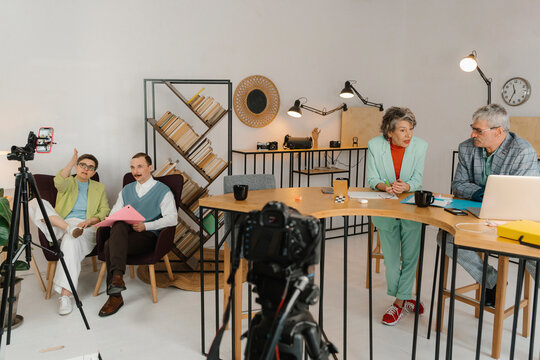 Business people recording online class in studio seen