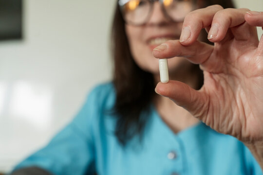 Doctor holding capsule in medical practice