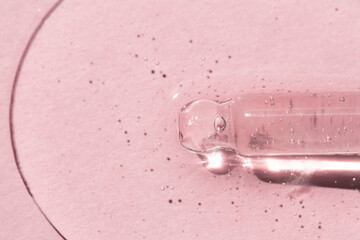 Cosmetic dropper with transparent skin serum, macro texture. Body care, beauty concept.