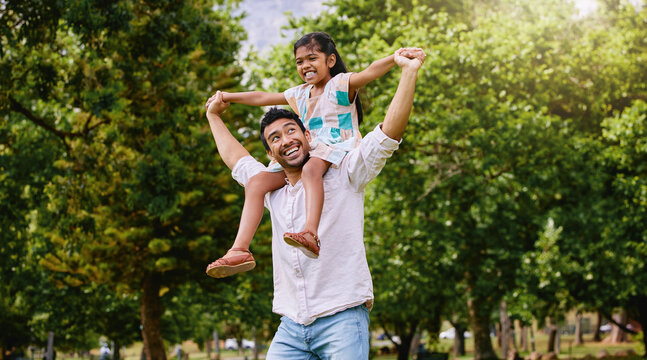 Indian father, daughter and shoulders in park with smile, airplane game or piggyback in nature on holiday. Man, girl and playing together in garden, woods or summer sunshine for happy family vacation