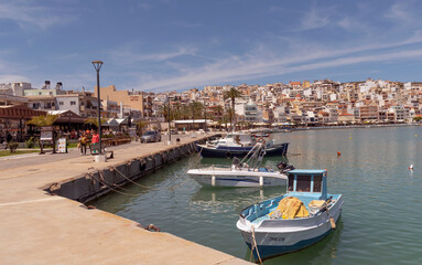 Sitia, Eastern Crete, Greece, Europe. 2023,  Waterfront of Sitia harbour in Eastern Crete with its small boats, hotels and restaurants on the seafront.
