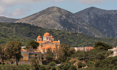 Fototapeta na wymiar Neopoli, Eastern Crete, Greece. 2023. Greek Orthodox church with a backdrop of mountains in eastern Crete, Greece.