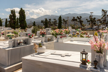 Malia, Eastern Crete, Greece, Europe. 2023.  An overview of Malia Cemetery with its tombstones and decorative flowers.