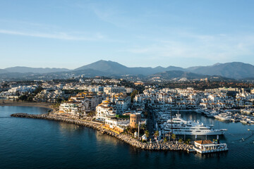 Aerial view of boats and yachts anchored at Puerto Banus harbour along the Mediterranean coastline, Andalusia, Marbella, Spain.