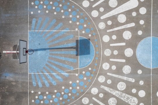 Follonica, Italy - 16 October 2022: Aerial view of a basketball court with graffiti on the ground, Tuscany, Italy.