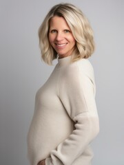 Obraz premium Portrait of a beautiful middle-aged woman in a white sweater