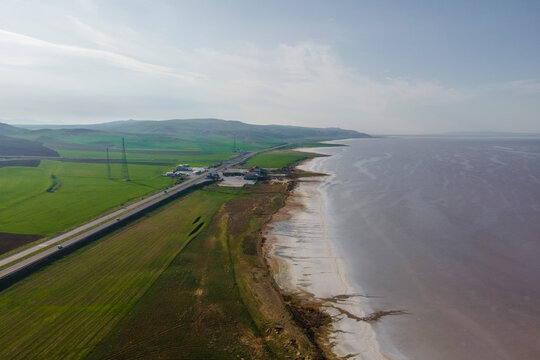 Aerial view of a road driving along the Tuz Golu (Lake Tuz), one of the largest hyper saline lake in the world, Central Anatolia Region, Turkey.