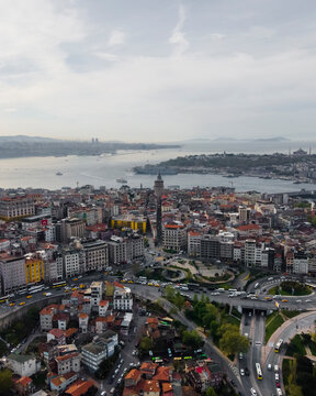 Aerial view of the Galata Tower in Beyoglu district on the European side at sunset along the Bosphorus channel and the Golden Horn river Estuary in Istanbul, Turkey.