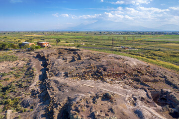 Drone view of Metsamor Archeological Site on the background of Mount Ararat on sunny summer day. Taronik, Armavir Province, Armenia.