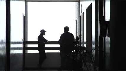 People are talking on the railing of building Floor in Night - Gujarat, India 29 April 2023

Business persons talking and walking on the floor with White Background.
Elevator Black and White scene