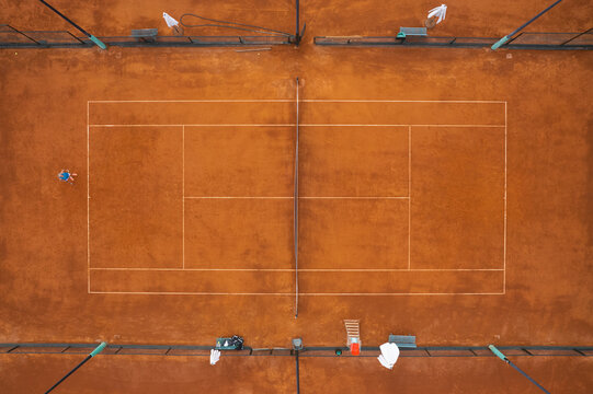 Aerial view of a tennis court club with a player waiting for his opponent, Trinitat, Valencia, Spain.