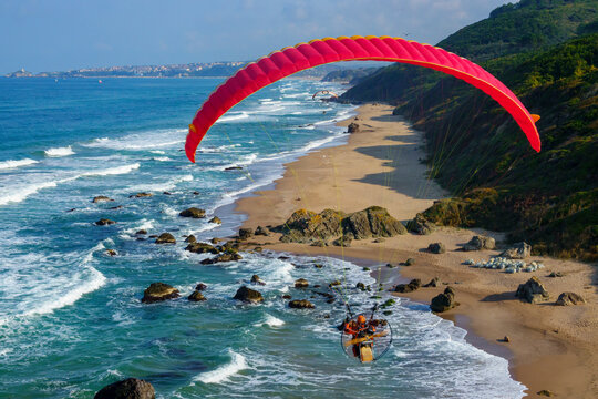 Aerial view of paramotor pilots flying along the Black Sea coast in Sile, Istanbul, Turkey.