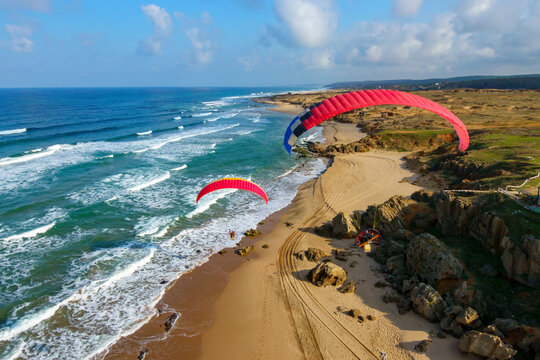 Aerial view of paramotor pilots flying along the Black Sea coast in Sahilkoy, Istanbul, Turkey.