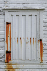 Old White Painted Wooden Door Or Shutter Showing Heavy Rust Staining From Hinges