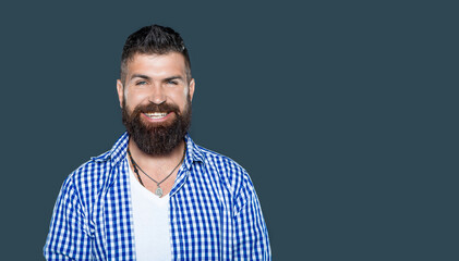glad bearded man wear checkered shirt on grey background