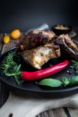 Roasted ribs with rosemary and sauces. On a wooden background
