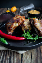 Roasted ribs with rosemary and sauces. On a wooden background