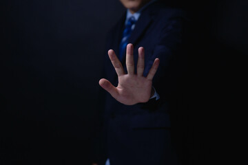 male hand showing stop gesture Concept of stop violence. Warning, prohibition, denial. On dark...