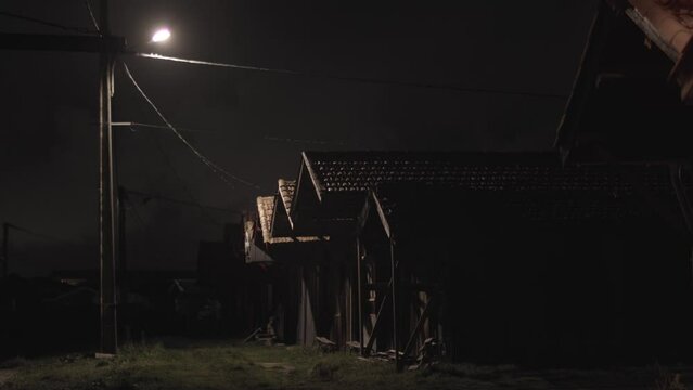 Eerie night scene cabins in darkness 