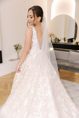 Naklejka premium Young bride in gorgeous wedding dress waiting for groom. Morning of bride 