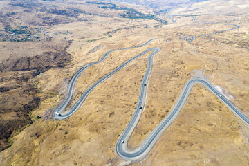 Aerial view of hairpin road nearby Vorotan Pass on sunny autumn day. Vayots Dzor Province, Armenia.