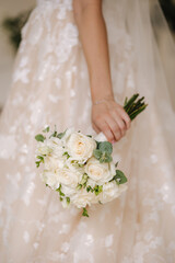 Close-up of bride hold wedding bouquet in hands