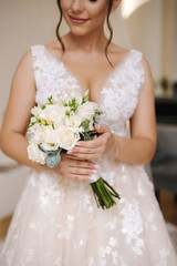Portrait of beautiful bride hold wedding bouquet. Attractive young woman in gorgeous wedding dress