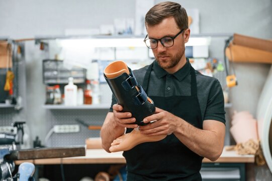 Holding prosthesis. Technician working in modern laboratory