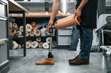 Prosthesis on the floor. Technician working in modern laboratory